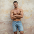 Man wearing men’s denim shorts styled for a casual summer look