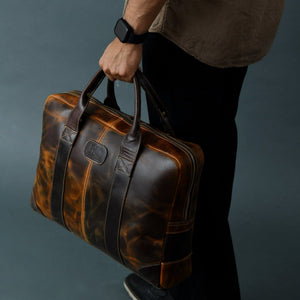 Brown Jefferson briefcase from Classy Leather Bags showing a sleek leather briefcase with handles and a front pocket.