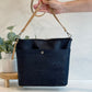 Carry Courage VISIONARY cross body bag in coal black, shown from the front with adjustable strap