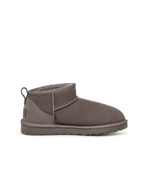 Grey UGG Women's Classic Ultra Mini footwear with plush sheepskin lining, showcased in a product image.