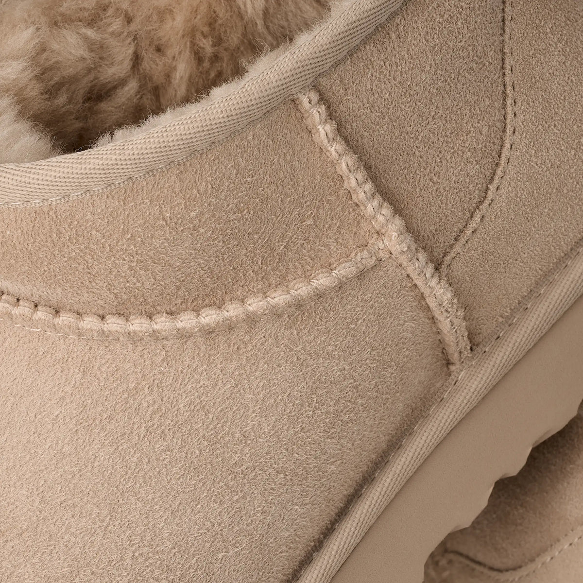UGG Women's Classic Ultra Mini Moonlight boots in soft suede, featuring plush sheepskin lining and a rugged rubber sole.