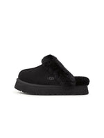 Black UGG Womens Disquette footwear featuring a sleek design and comfortable fit, shown on a model.