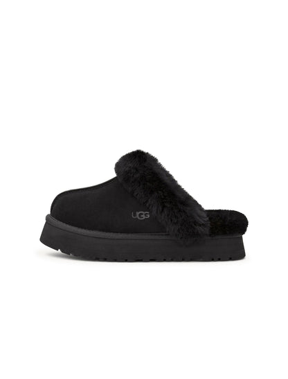 Black UGG Womens Disquette footwear featuring a sleek design and comfortable fit, shown on a model.
