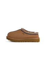 UGG women's Tasman II chestnut footwear with sheepskin lining and slip-on design, displayed on a wooden surface.