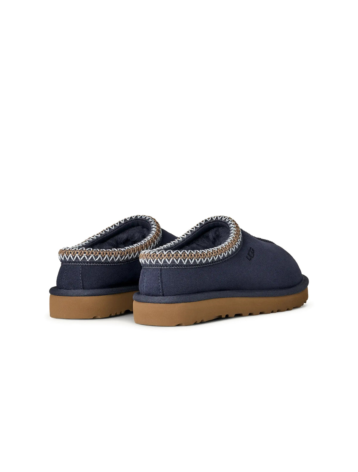 Dark indigo UGG Women's Tasman II footwear with sheepskin lining, displayed in a natural indoor setting.