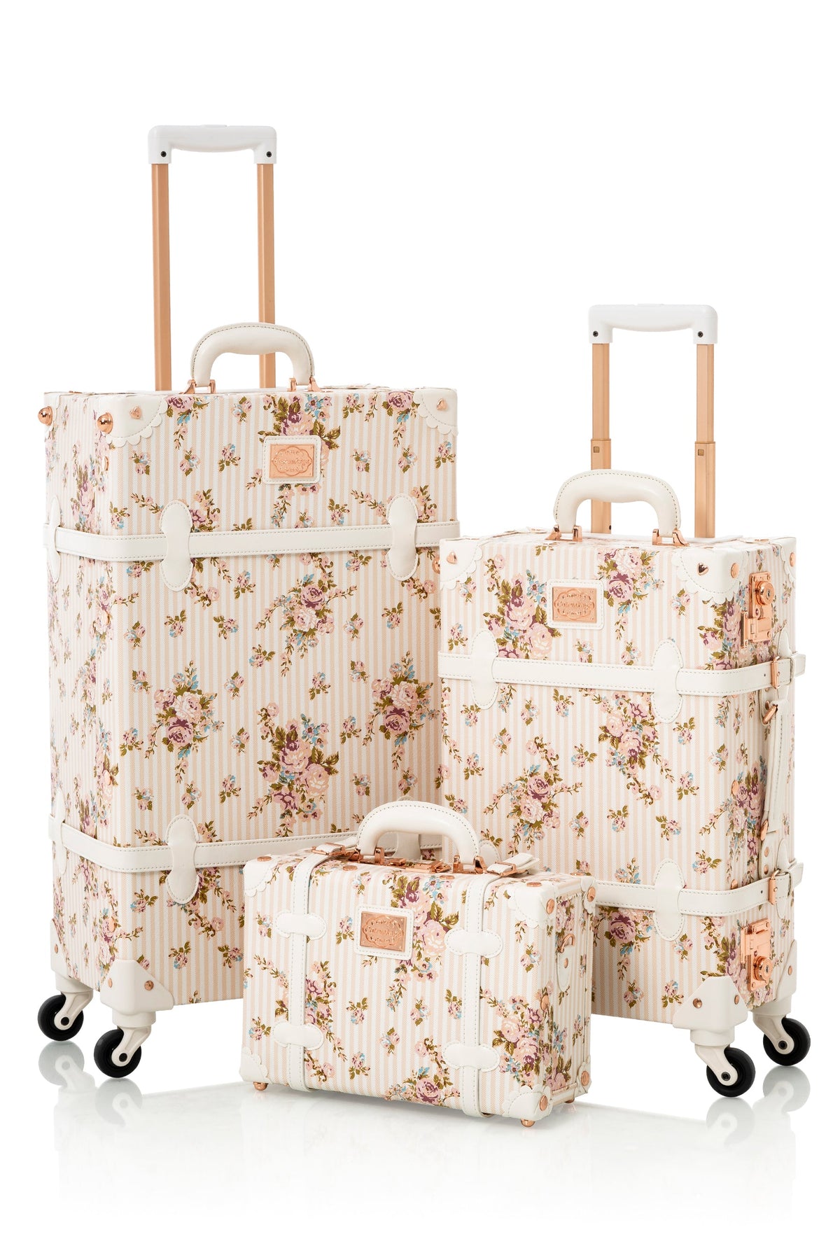 COTRUNKAGE Botanica 3-piece beige floral luggage set with rolling suitcases and carry-on bags, featuring floral patterns and sturdy handles.