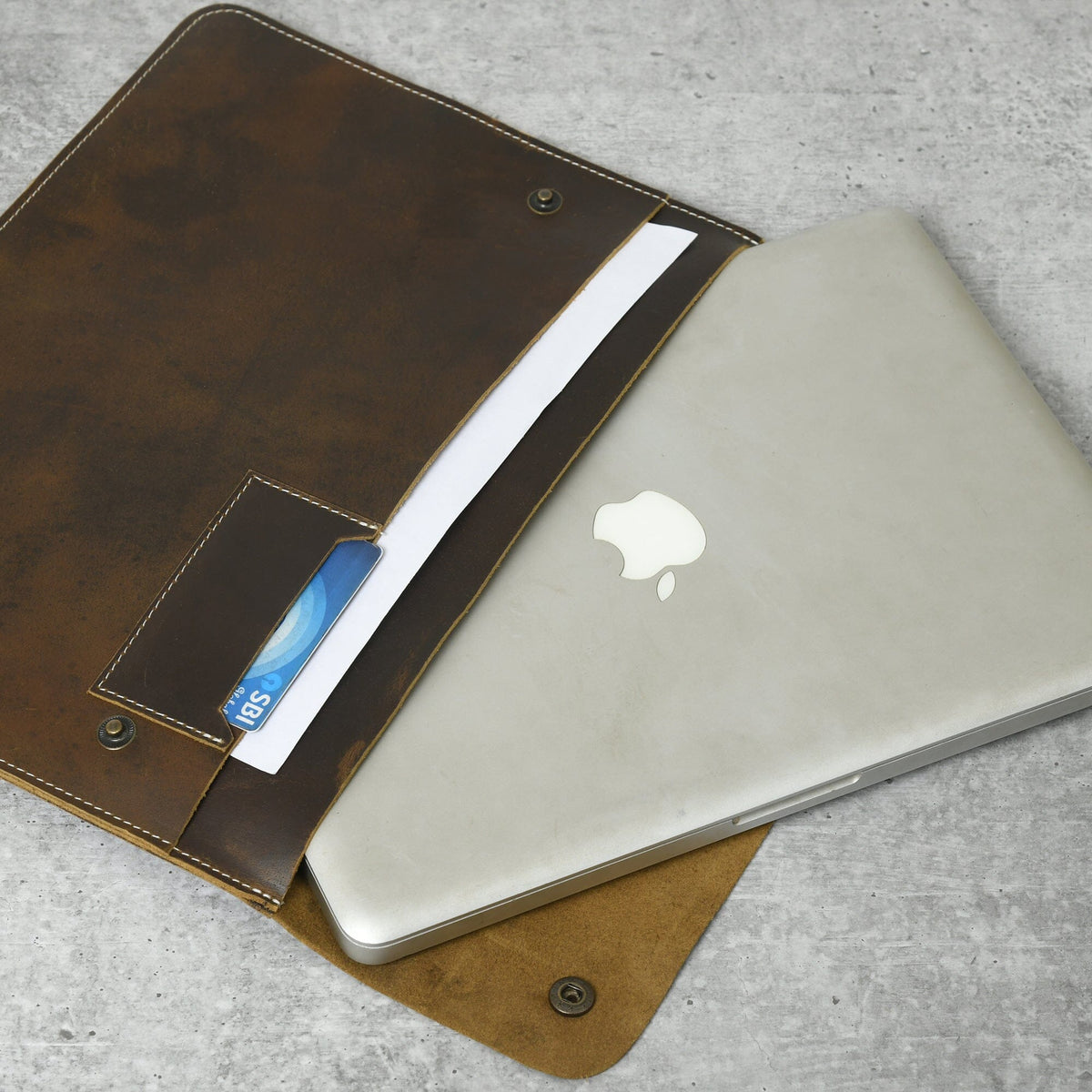 Classy Leather Bags MacBook Folio laptop sleeve in black leather, slim design with secure closure for MacBook protection.