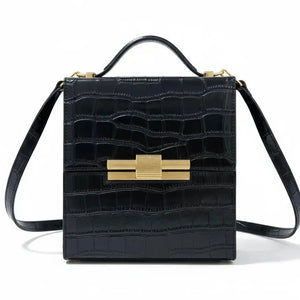 Leather Nina cigar box bag by thebagicon with a structured rectangular shape and metal clasp closure.