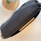 Carry Courage NOMAD messenger bag in coal gray, showing its sleek crossbody design and adjustable shoulder strap