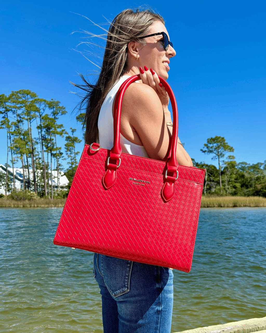Baldwin Baby Company Montrose diaper bag tote in cardinal red, shown in a lifestyle setting