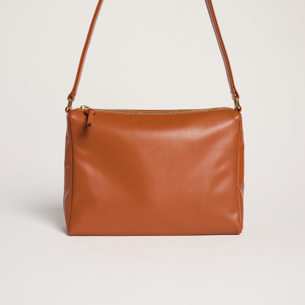 Allégorie brown Gala shoulder bag with sleek design, featuring a top handle and adjustable strap, on a neutral background.