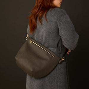 Dark grey Allégorie Pineapple Hobo Fanny Bag with adjustable strap and pineapple logo, stylish and functional accessory.
