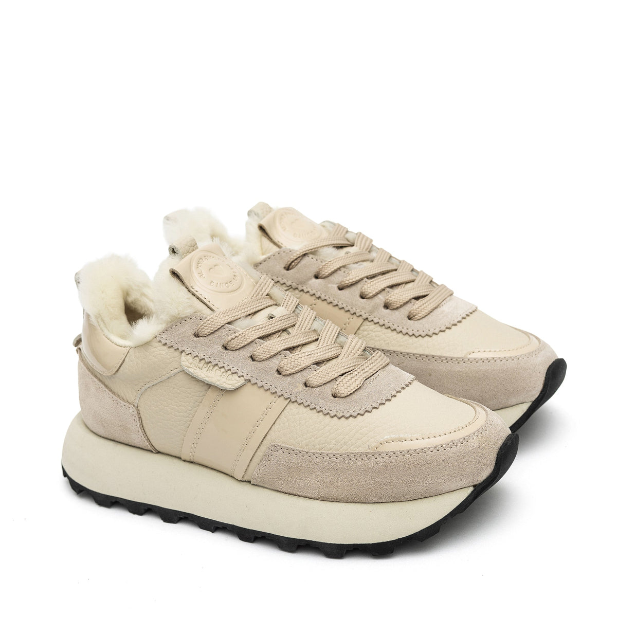 Alaska® Outerwear Company Alpine Shearling Sneaker showing tan shearling-lined shoes with laces and rugged sole.
