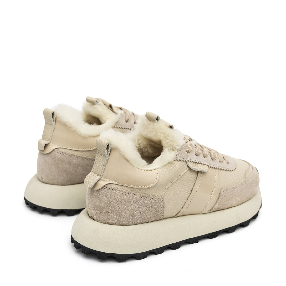 Alaska® Outerwear Company Alpine Shearling Sneaker showing beige shearling-lined shoes with laces and rugged sole.