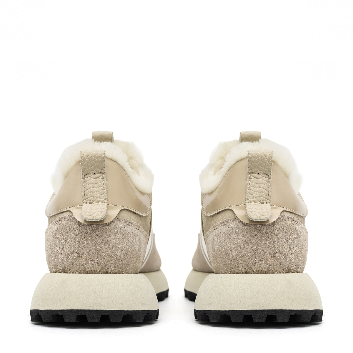 Alaska® Outerwear Company Alpine Shearling Sneaker showing beige shearling-lined shoes with laces and a casual design.