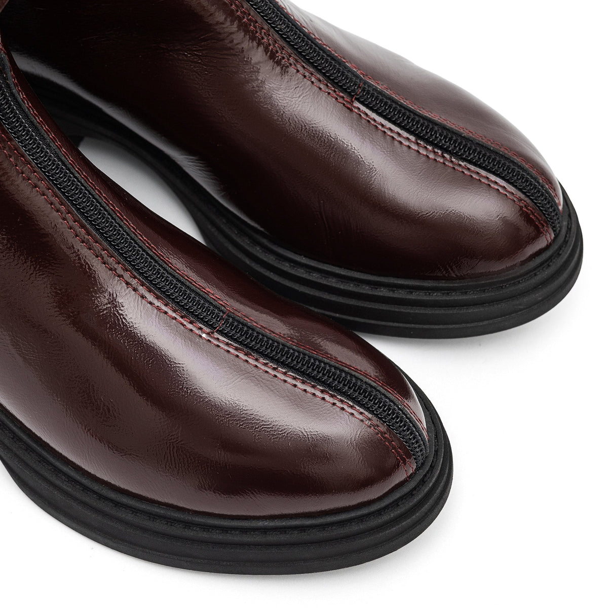 Bordeaux leather zip boots by Alaska® Outerwear Company, stylish shoes with side zipper and ankle-length design.