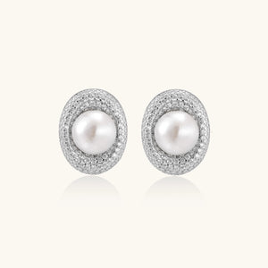 Elegant stud earrings with cream freshwater pearls surrounded by sparkly pavé crystals on rhodium-plated silver setting