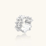 Wide band ring with sculptural wave ripples in polished white gold plated eco-brass on cream background