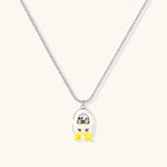Chrome egg-shaped pendant with kawaii face, yellow bow, and pearl detail on silver chain against white background