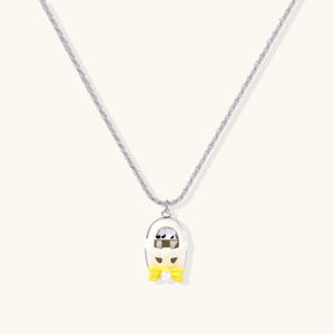 Chrome egg-shaped pendant with kawaii face, yellow bow, and pearl detail on silver chain against white background
