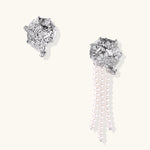 Silver-toned sculptural panther head earrings with zirconia details and white pearl drops on cream background