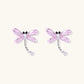Long drop earrings with translucent lavender enamel dragonfly wings and white gold plated segmented bodies on white background