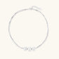 Sterling silver multi-strand necklace with three brushed round beads on cream background