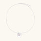 Sterling silver disc necklace with textured finish and centered freshwater pearl on delicate chain