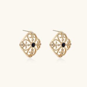 Gold filigree stud earrings with navy lapis lazuli center stone and mother-of-pearl accents in ornate quatrefoil design