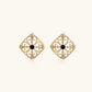 Gold filigree stud earrings with navy lapis lazuli center stone and mother-of-pearl accents in ornate quatrefoil design