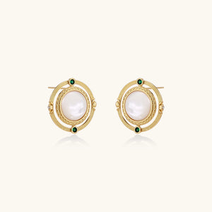 Circular gold stud earrings with iridescent mother-of-pearl center and green zirconia accents on cream background.