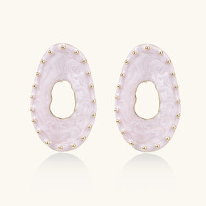 Oval lavender enamel earrings with marbled finish and gold-plated beaded border on cream background.