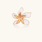 Gold-plated sculptural ring featuring white enamel petals forming an oversized lily bloom on adjustable band