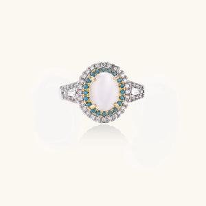 Vintage-style cocktail ring with luminous cat's eye center stone surrounded by turquoise and crystal double halo on white gold plated band