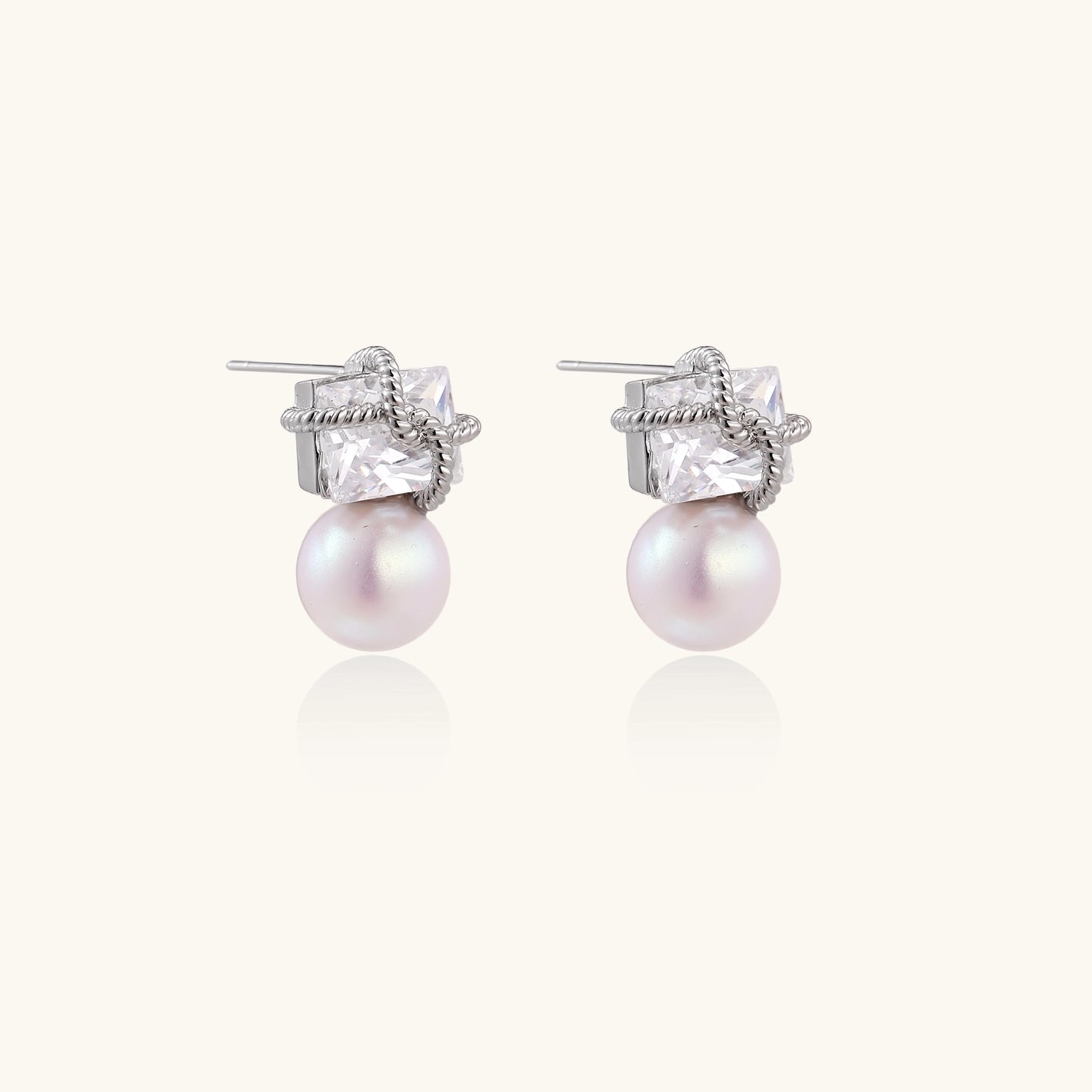 White gold stud earrings with square crystal stones in twisted frames and pink freshwater pearl drops below