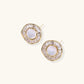 14K gold-plated stud earrings with freshwater pearl center surrounded by baguette-cut crystal halo in sunburst design