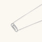 White gold plated necklace with dual-frame geometric pendant featuring crystal pavé border on pale background.