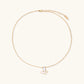 Gold-plated butterfly pendant with iridescent mother of pearl inlay on delicate chain against cream background.