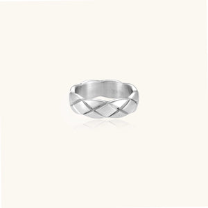 Braided stainless steel band ring with geometric interwoven strands in brushed silver finish on white background