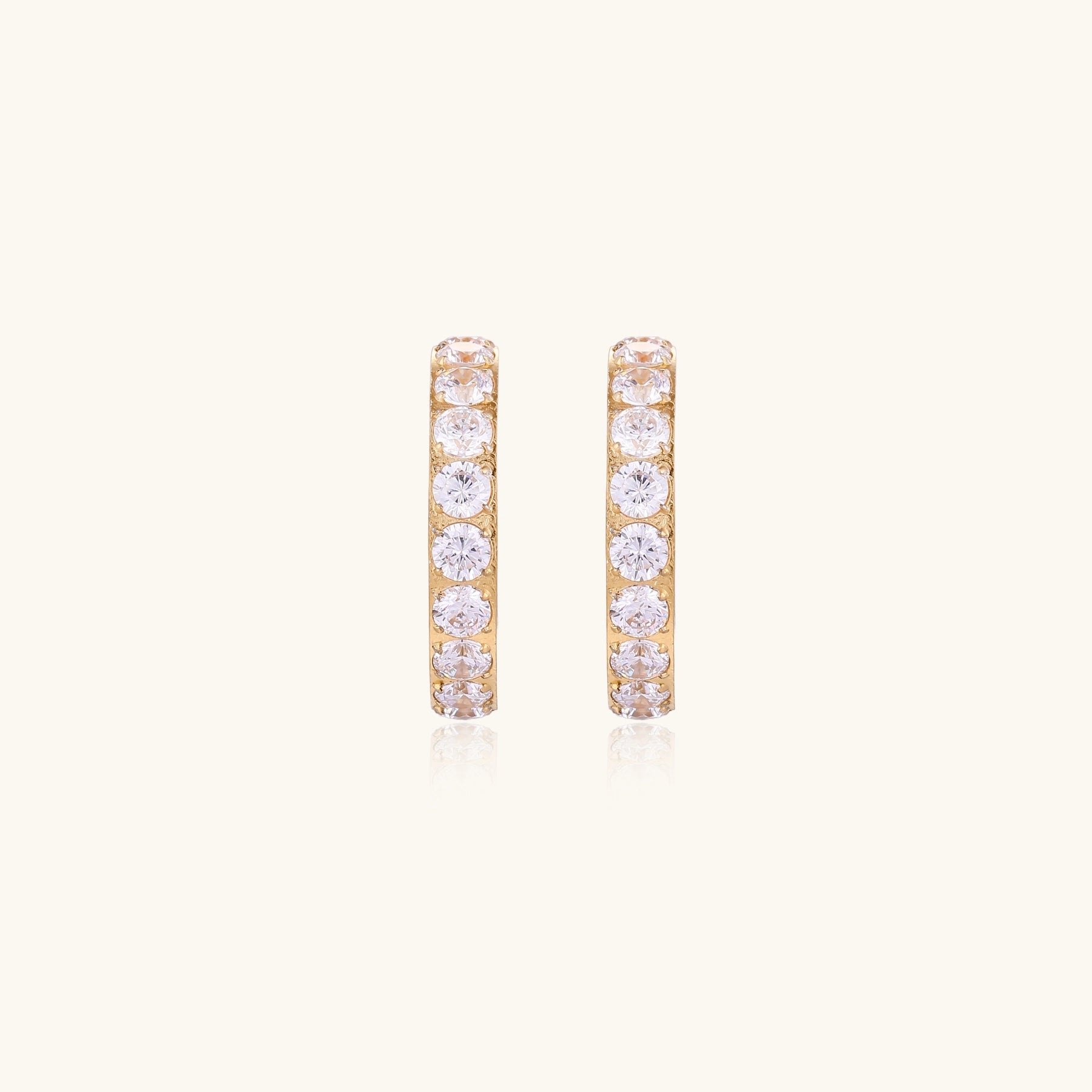 Gold pavé hoop earrings with two freshwater pearls nestled inside the curved design, featuring crystal-studded outer edge.