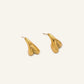 Organic sculptural gold stud earrings with fluid matte finish on cream background