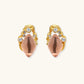 Gold-plated baroque stud earrings with coral-pink liuli stones and cubic zirconia crystals on white background.