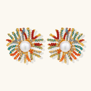 Vibrant starburst stud earrings with multicolor enamel rays and white pearl centers on gold-plated setting