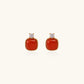 18K gold vermeil stud earrings with cushion-cut red agate stones and sparkling crystal accents on beige background
