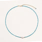 Delicate gold vermeil necklace with teal apatite beads and freshwater pearl on white background.