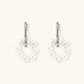 Rhodium-plated silver hoop earrings with freshwater pearls arranged in crescent formation and diamond accents