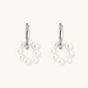 Rhodium-plated silver hoop earrings with freshwater pearls arranged in crescent formation and diamond accents