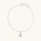 Oval sterling silver pendant with crystal halo surrounding a white freshwater pearl on delicate chain