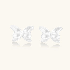 Pair of translucent butterfly-shaped stud earrings with frosted finish and dimensional wing details on white background