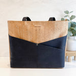Carry Courage ADVOCATE zippered tote in coal black, shown from the front with handles and zip closure